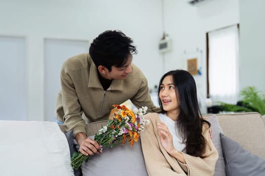 Young couple Hug and giving flower on Valentine's Day. Romantic day together. Valentine's Day concept.