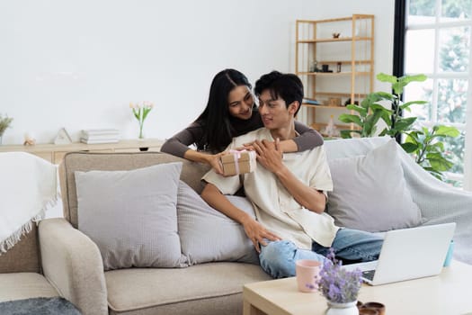 Young couple Hug and giving present on Valentine's Day. Romantic day together. Valentine's Day concept.