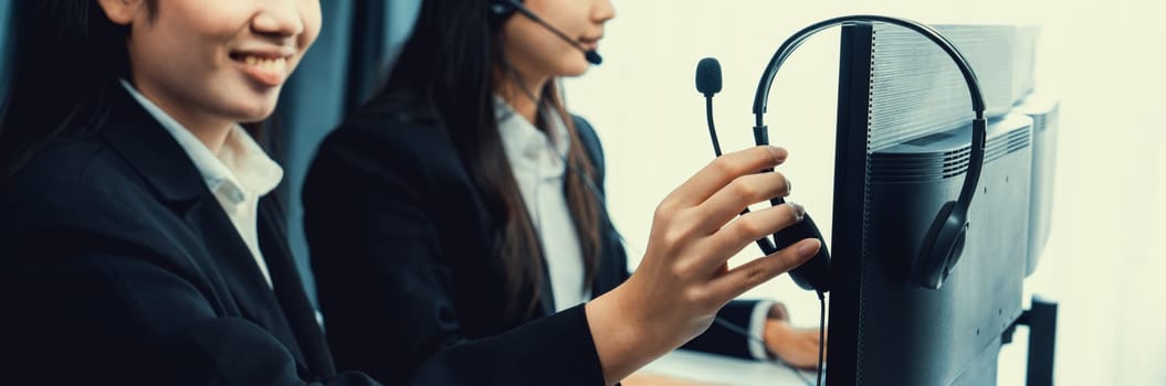 Business people wearing headset working in office to support remote customer or colleague. Call center, telemarketing, customer support agent provide service on telephone video conference oratory call