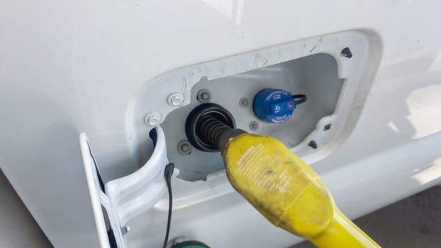 Denver, Colorado, USA-July 7, 2021-In the heart of rural America, a white truck is being refueled at a local gas station.