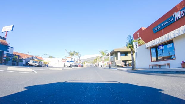 Santa Maria, California, USA-December 6, 2022-Car driving through the streets of Pismo Beach town, California during winter.