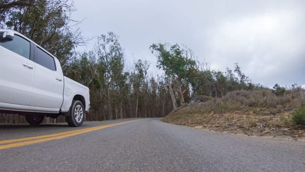 Santa Maria, California, USA-December 6, 2022-In this serene winter scene, a vehicle carefully makes its way along Los Osos Valley Road and Pecho Valley Road within Montana de Oro State Park.