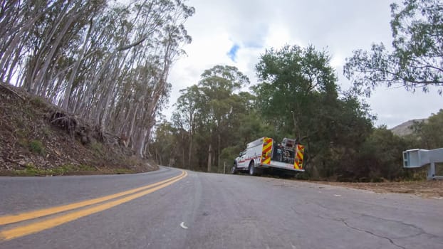 Santa Maria, California, USA-December 6, 2022-In this serene winter scene, a vehicle carefully makes its way along Los Osos Valley Road and Pecho Valley Road within Montana de Oro State Park.