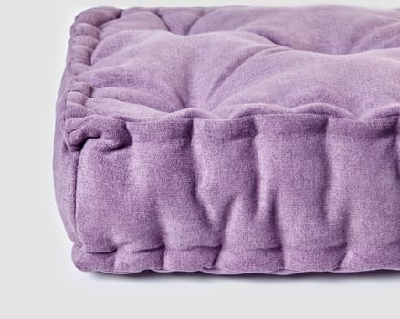 Detailed close-up of plush purple linen cushion, highlighting texture and comfortable design of home decor textiles