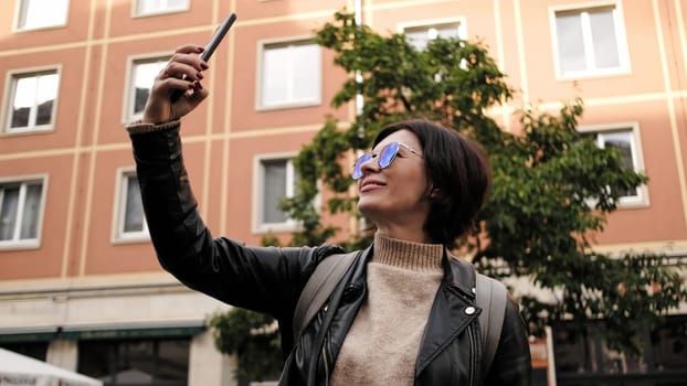 Attractive Female Tourist Walks In Historical Center Of Dresden, Taking A Selfie