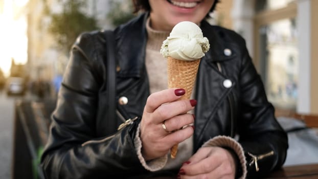 Stylish Female Enjoys Holding Tasty Ice Cream In Waffles While Exploring City Streets