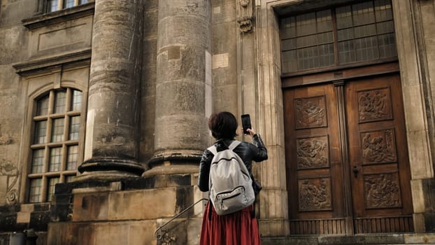Attractive Female Tourist Walks With Germany Flag In Dresden'S Historical Center, Taking Pictures Of Sightseeing Spots
