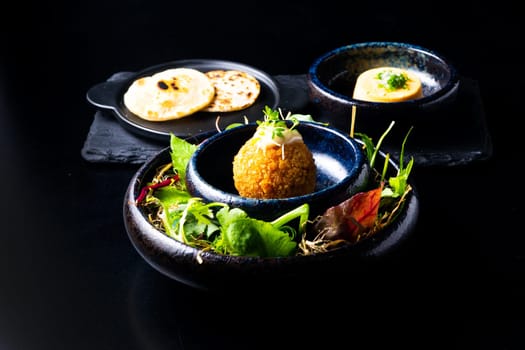 Closeup of some spanish croquettes in bed of lettuce served as tapas