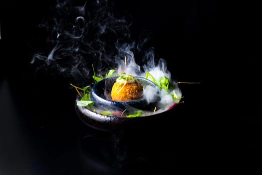 Closeup of some spanish croquettes in bed of lettuce served as tapas