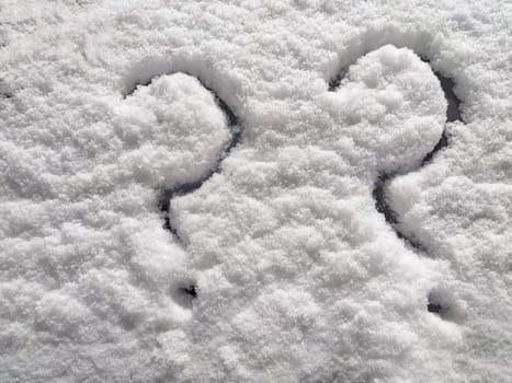 Two question marks written in snow. The cold frosty texture of the snow and the question mark. Background, place for text, copy space