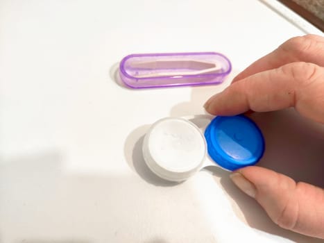 Set for contact lenses with a container, forceps, glasses. The concept of correcting myopia. Contact lens care, cleaning, health. Background, copy space