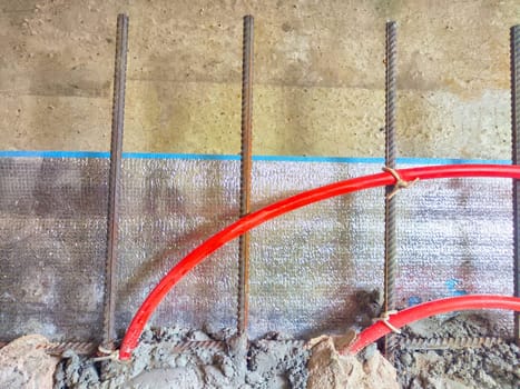 Installation of polypropylene pipes for underfloor heating systems, concrete floor filling