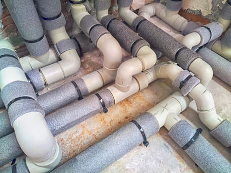 Complex Network of Insulated Pipes in an Industrial Setting. maze of thermally insulated pipes arranged in a complex network, part of an industrial heating or cooling system