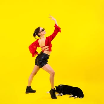 Beautiful sport female with border collie in a studio