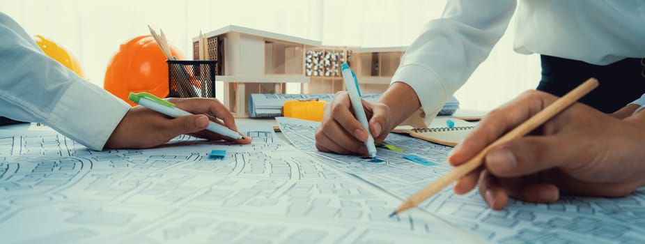 Worker, architect and engineer work on real estate construction project oratory planning with cartography and cadastral map of urban town area to guide to construction developer business plan of city