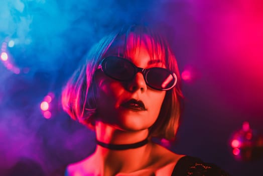 Portrait of young pretty woman in neon light. Pussy cat costume for halloween party. Sexy elegant lady with sunglasses and lace ears. High quality 4k footage