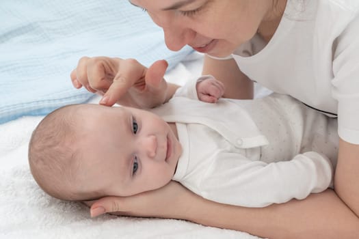 Mother strokes baby head with tenderness.