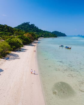 Drone aerial view at Koh Kradan a tropical island with palm trees soft white sand, and a turqouse colored ocean in Koh Kradan Trang Thailand