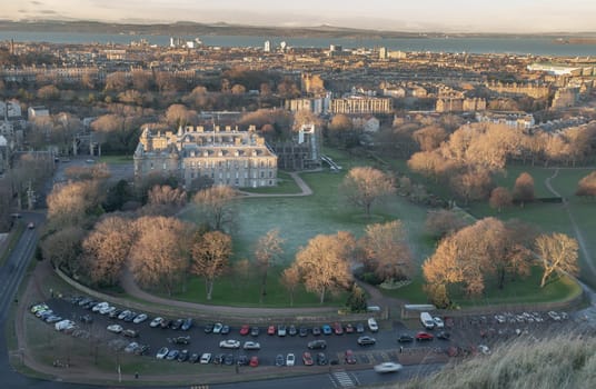 Edinburgh, Scotland - Jan 17, 2024 - Aerial view of Palace of Holyroodhouse and Holyrood Park seen from the top of Salisbury Crags. Amazing Edinburgh Cityscape, Destinations in Europe, Space for text.