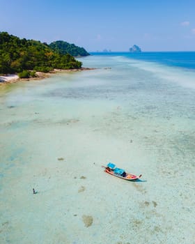 Drone aerial view at Koh Kradan a tropical island with palm trees soft white sand, and a turqouse colored ocean in Koh Kradan Trang Thailand