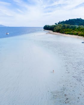 aerial view at Koh Kradan a tropical island with palm trees soft white sand, and a turqouse colored ocean in Koh Kradan Trang Thailand