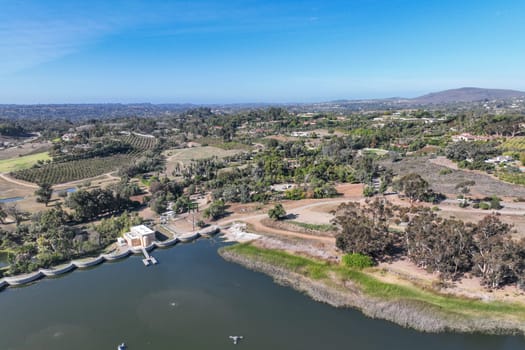 Aerial view over water reservoir and a large dam that holds water. Rancho Santa Fe in San Diego, California, USA