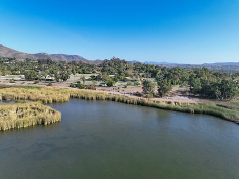 Aerial view over water reservoir and a large dam that holds water. Rancho Santa Fe in San Diego, California, USA