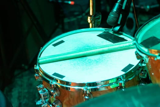 Drum kit in green light close up top wiew