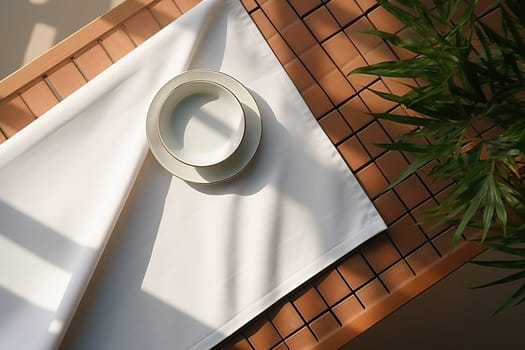 Cafe interior. Top view of an empty white cup on a white napkin.