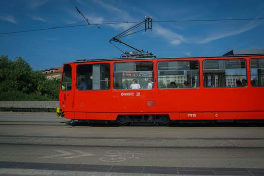 Bratislava, Slovakia - August 25, 2023: Tramway passing on a cobblestone road in Bratislava, Slovakia. High quality photo