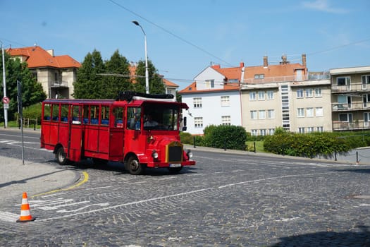 Bratislava, Slovakia - August 25, 2023 - a bright red tourist bus rides through the city streets. High quality photo