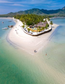 Drone aerial view at Koh Muk a tropical island of white sand, and a turqouse colored ocean in Koh Mook Trang Thailand, top view at a sandbar in a blue ocean