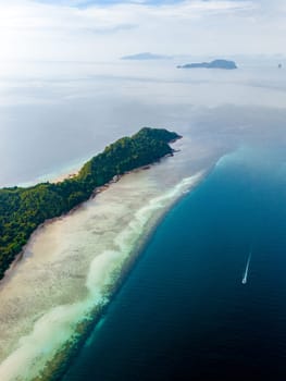 Drone top aerial view at Koh Kradan a tropical island with palm trees soft white sand, and a turqouse colored ocean in Koh Kradan Trang Thailand
