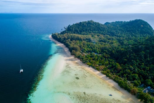 top aerial view at Koh Kradan a tropical island with palm trees soft white sand, and a turqouse colored ocean in Koh Kradan Trang Thailand