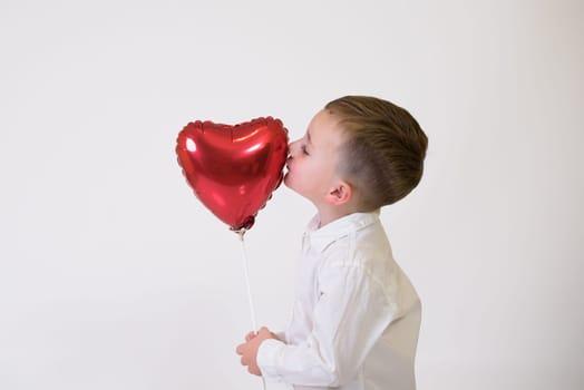 Little children with air balloons on white background. Valentine's Day Celebration.