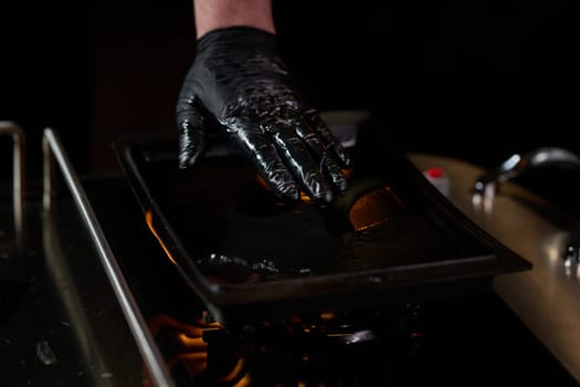 Close-up shot, a professional chef expertly prepares a delicious steak using modern cooking techniques, showcasing culinary excellence and precision in the art of gourmet cuisine.