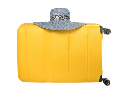 Travel yellow suitcase with blue hat isolated on white background. Plastic travel suitcase with hanging hat. Travel vacation concept with space for your copy on suitcase