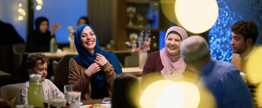 Grandparents arrive at their children's and grandchildren's gathering for iftar in a restaurant during the holy month of Ramadan, bearing gifts and sharing cherished moments of love, unity, and cultural exchange, as they eagerly await their meal together.