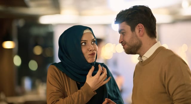 Islamic European couple shares laughter and enjoyment while savoring delicious pastries during iftar in the holy month of Ramadan, epitomizing joy, cultural celebration, and culinary delight.