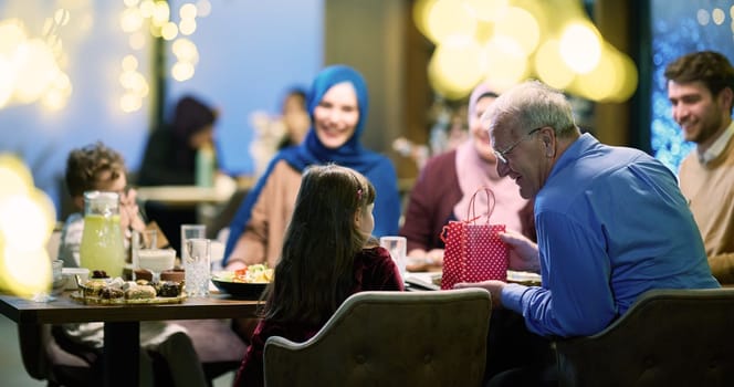 Grandparents arrive at their children's and grandchildren's gathering for iftar in a restaurant during the holy month of Ramadan, bearing gifts and sharing cherished moments of love, unity, and cultural exchange, as they eagerly await their meal together.