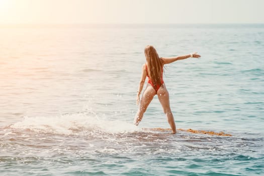 Woman sea yoga. Back view of free calm happy satisfied woman with long hair standing on top rock with yoga position against of sky by the sea. Healthy lifestyle outdoors in nature, fitness concept.