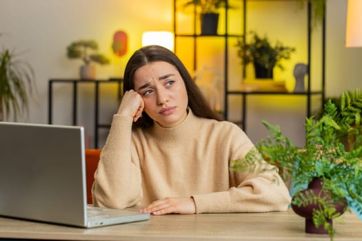 Portrait of sad woman looks pensive thinks over life concerns or unrequited love, suffers from unfair situation. Problem, break up, depressed feeling bad annoyed, burnout. Girl at home office at table