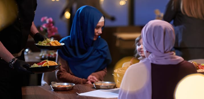 A modern and traditional European Islamic family comes together for iftar in a contemporary restaurant during the Ramadan fasting period, embodying cultural harmony and familial unity amidst a culinary celebration of diversity.