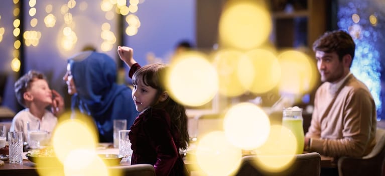 In a modern restaurant, an Islamic couple and their children joyfully await their iftar meal during the holy month of Ramadan, embodying familial harmony and cultural celebration amidst the contemporary dining ambiance.