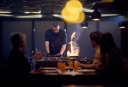 In a restaurant setting, a professional chef presents a sizzling steak cooked over an open flame, while an European Muslim family eagerly awaits their iftar meal during the holy month of Ramadan, blending culinary artistry with cultural tradition in a harmonious dining experience.