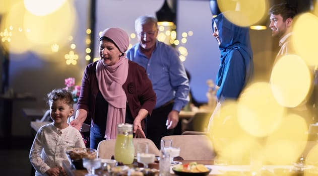 Grandparents arrive at their children's and grandchildren's gathering for iftar in a restaurant during the holy month of Ramadan, bearing gifts and sharing cherished moments of love, unity, and cultural exchange, as they eagerly await their meal together.