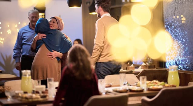 Grandparents arrive at their children's and grandchildren's gathering for iftar in a restaurant during the holy month of Ramadan, bearing gifts and sharing cherished moments of love, unity, and cultural exchange, as they eagerly await their meal together.