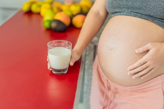 Weighing the pros and cons of milk during pregnancy, a thoughtful pregnant woman stands in the kitchen with a glass, contemplating the decision to include or avoid milk for her and her baby's well-being.