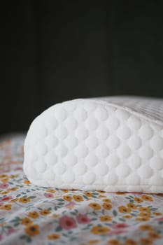 Orthopedic memory foam pillow on bed .