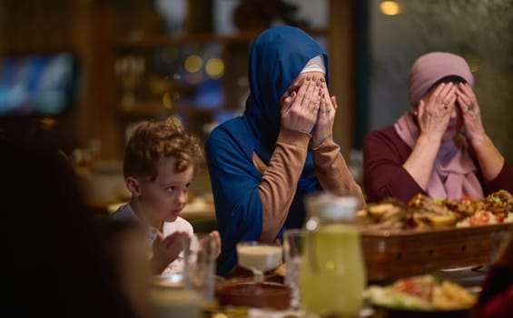 In a modern restaurant setting, a European Islamic family comes together for iftar during Ramadan, engaging in prayer before the meal, uniting tradition and contemporary practices in a celebration of faith and family.